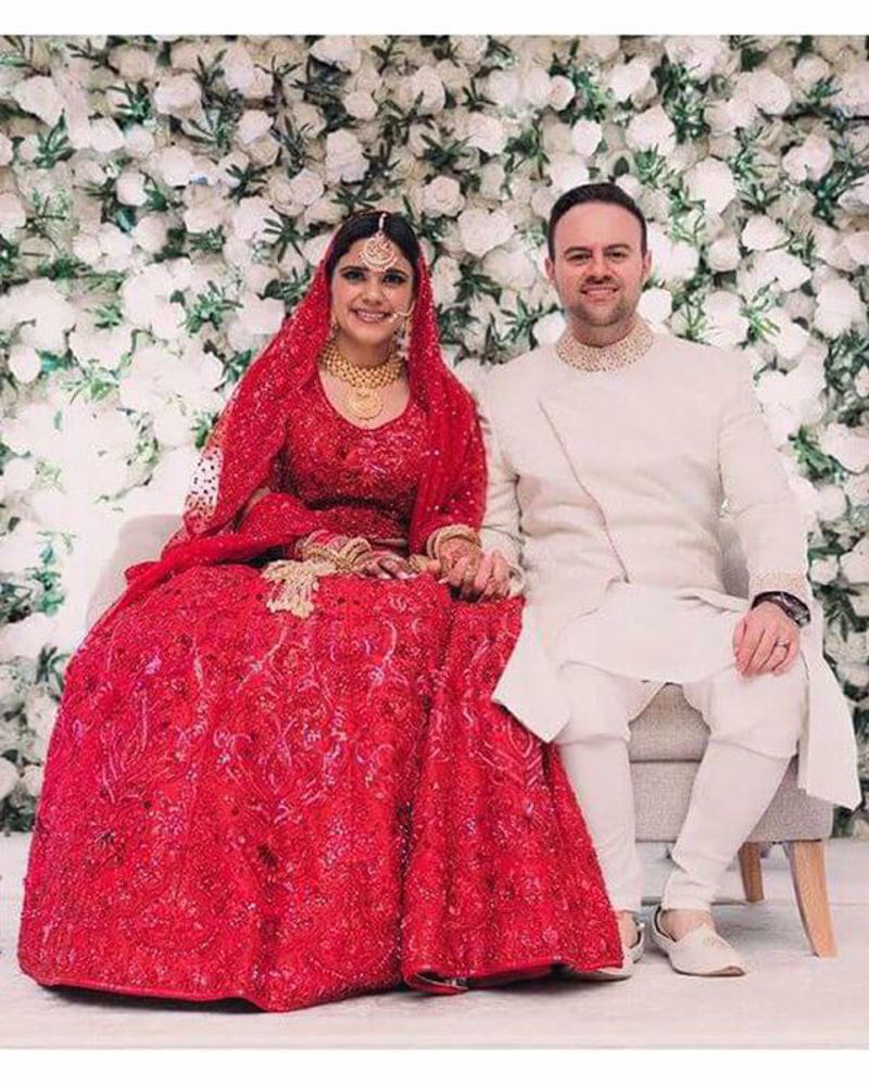 Picture of Alessandro and Alicia look truly lovely, with the bride lighting up the night in our elaborate red-on-red, handcrafted lehnga and choli