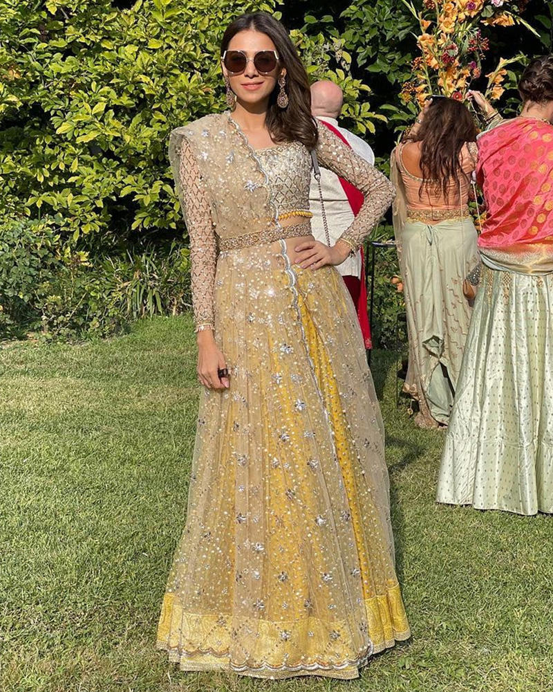Picture of Understated elegance, with our most loved sequinned net lehnga in an ivory and yellow combination adorned by Tooba Siddiqui.