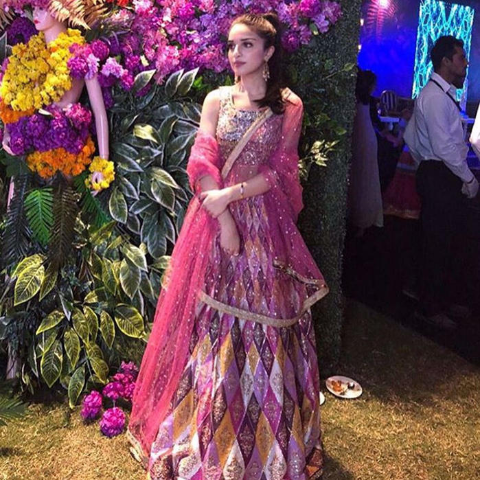 Picture of ToobaBaig is an alluring vision in a coral peachy #NomiAnsari lehnga