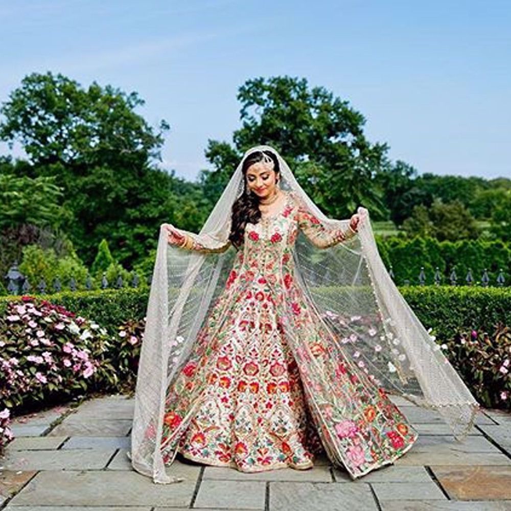 Picture of Asiya zehra Pathan stuns in this beautifully hand crafted net front open jacket. The lehnga and the jacket is adorned with hand embroidered florals. She drapes an ivory embellished net dupatta.
