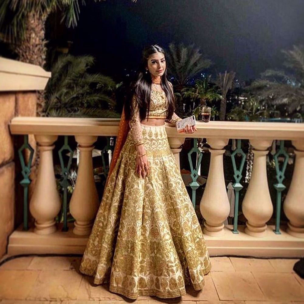 Picture of Iman Baig spotted wearing an ivory and Gold lehenga by #nomiansari at a recent #wedding in #dubai