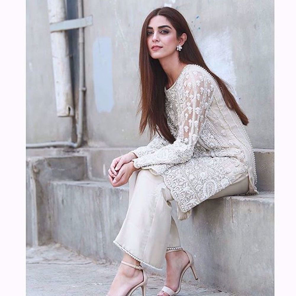 Picture of Maya Ali wears an ivory tulle net beaded mid length shirt paired with silk pants for her upcoming film promotion #pareyhutlove