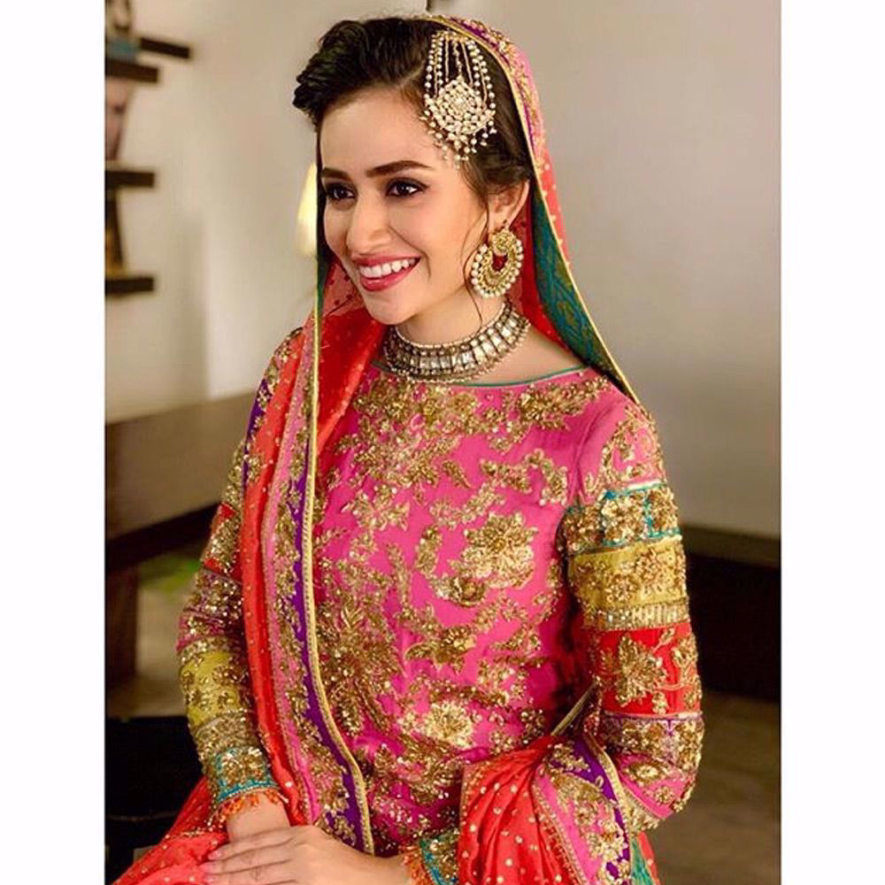 Picture of Meet the bride @sanajaved.official looks million dollar in this rani pink chatapati bridal ensemble by Nomi Ansari for her upcoming Drama serial.