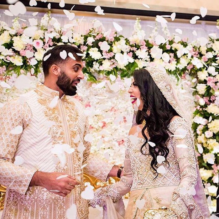 Picture of Moiz wears a #white embroidered waistcoat and kurta paired with a white straight pants by #NomiAnsari at his engagement in #usa