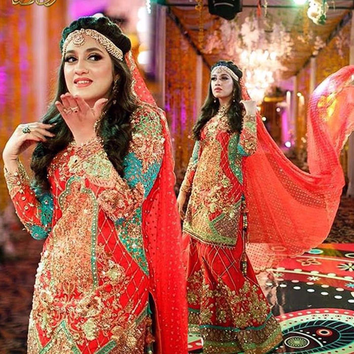 Picture of Neelam wears a Coral #nomiansari Dhaka pyjama and straight short shirt with multi appliqués and hand embroidery details with zardozi and Swarovski Crystals and Pearls at her #mehndi