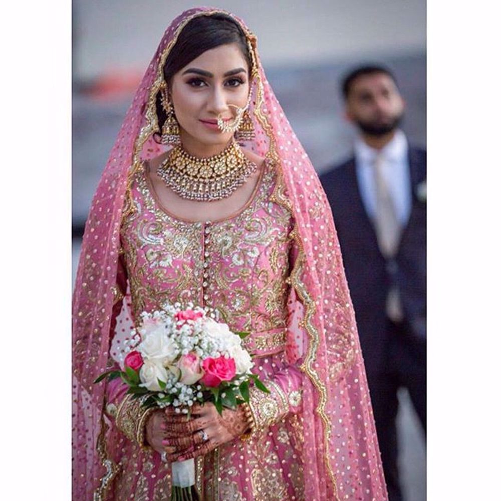 Picture of The beautiful #bride Durezehra Naqvi wears our signature long tulle gown with an embellished #lehenga and scalloped dupatta in #Florida #USA