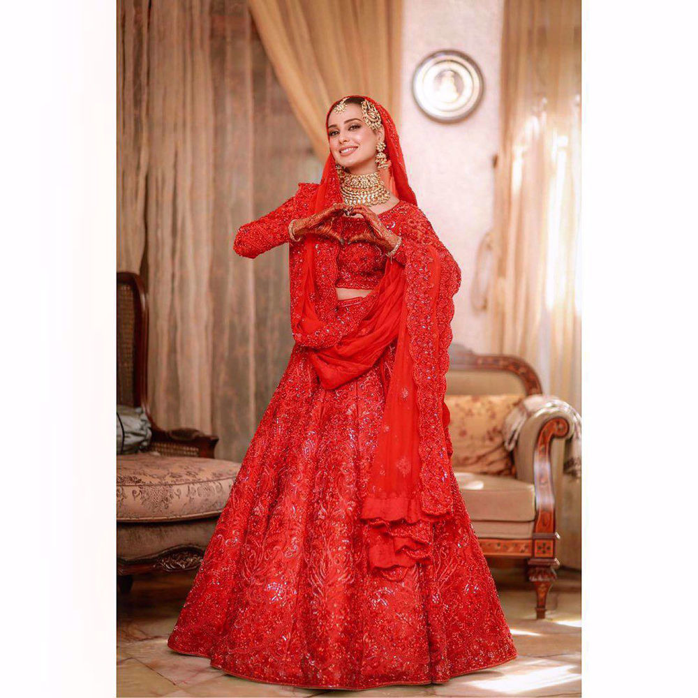 Picture of Iqra - a distinct all red full sleeved choli and heavy lehnga, fully bedazzled with red-on-red embroidery and hand worked embellishments that include sequins, gemstones and more