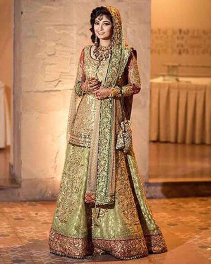 Picture of A dazzling, gold bridal ensemble for a traditional look in our signature aesthetic of immaculate craftsmanship and colour play