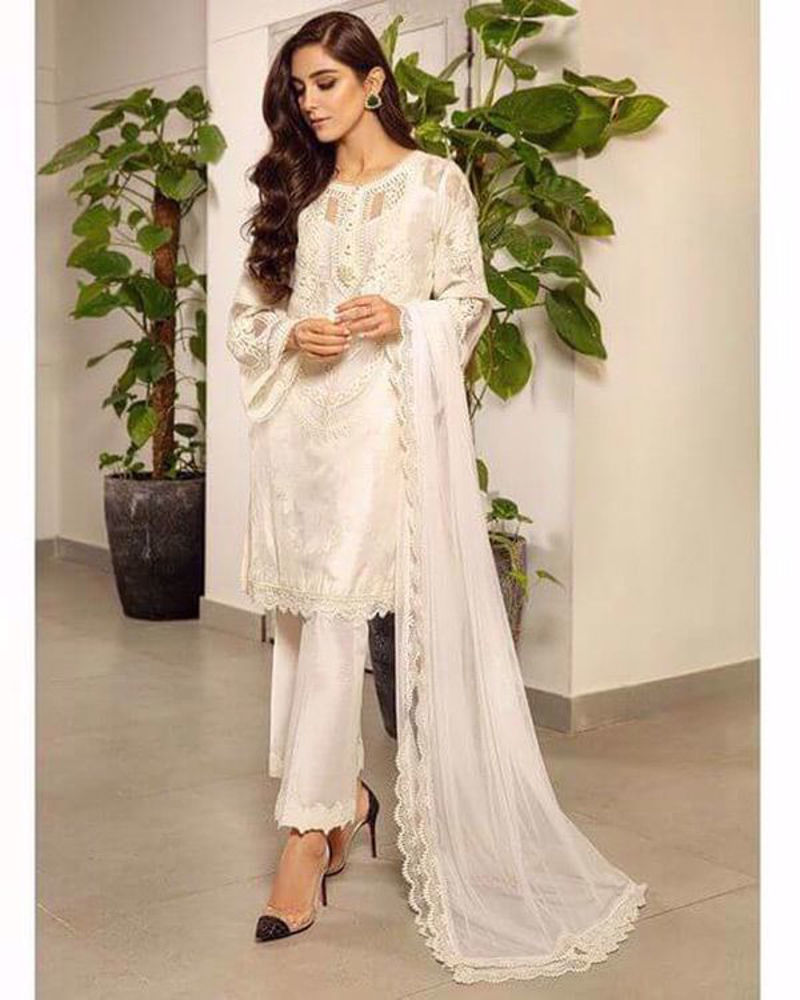 Picture of Maya looking ever graceful in a sleek white-on-white number with a smart embroidered neckline design and embroidered sleeves