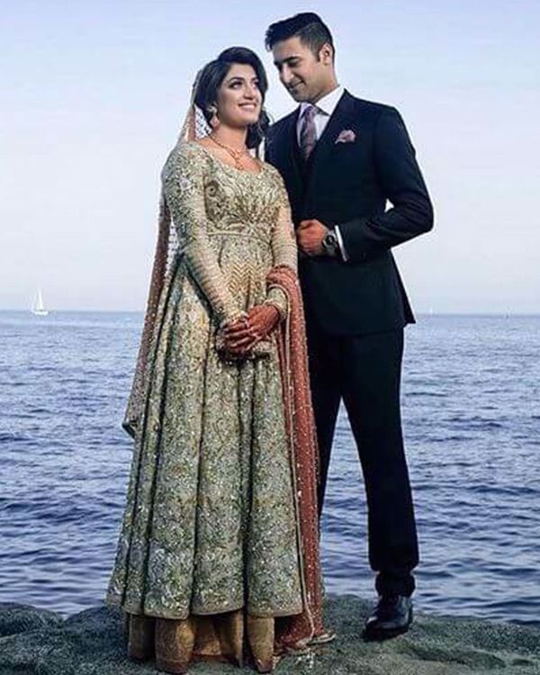 Picture of The beautiful bride wears our signature pishwaas with gold and silver kaam on an ivory base, paired with a peach chiffon dupatta to give it a subtle colour accent