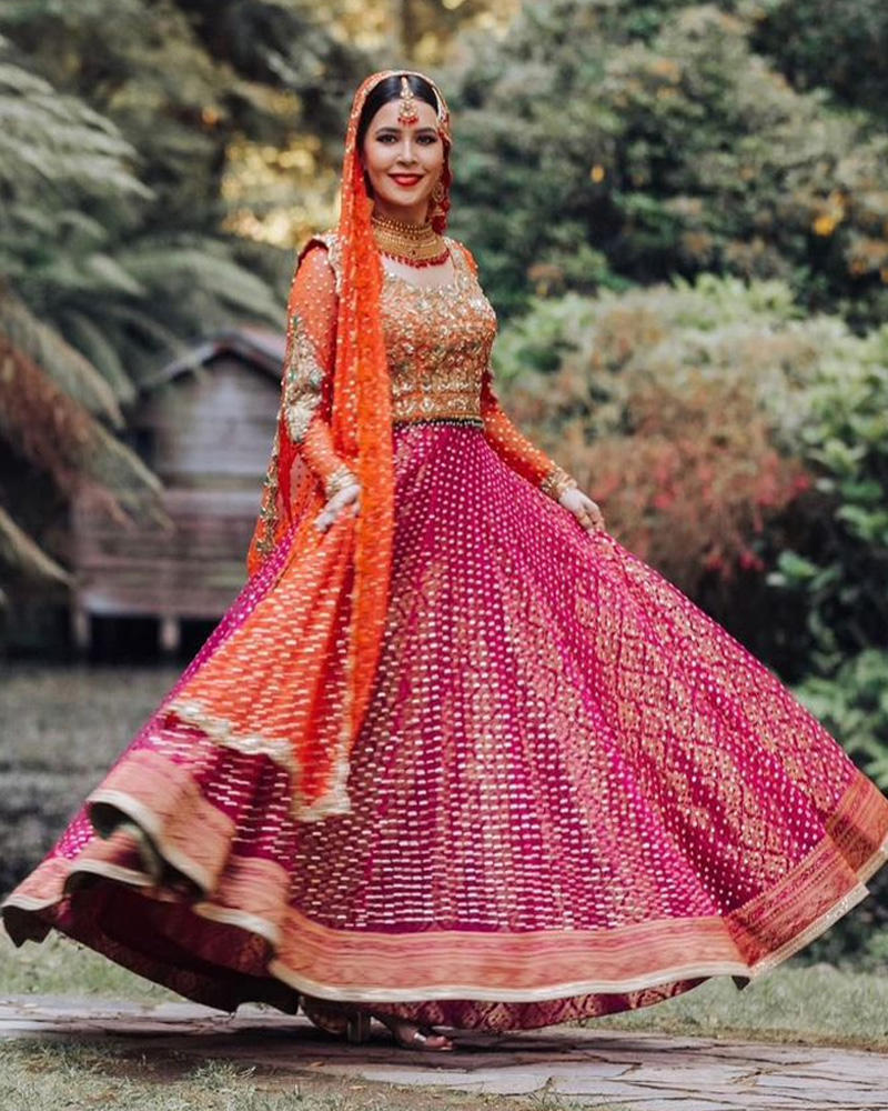 Picture of Zainab makes a pretty mehndi bride in this plum and orange combination, with a touch of blue accents and classic gold hand work.