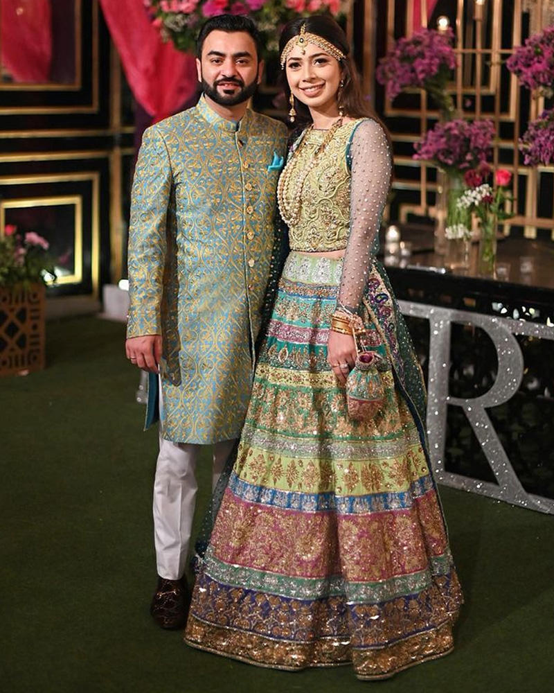 Picture of Beautifully bespoke custom made ensembles for Neha and Hamza, in vibrant peacock shades with impeccable embroideries and handworked details.