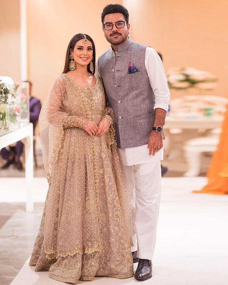 Picture of A subtle ash grey base with detailed gold kaam in this traditional anarkali, worn by Iqra Aziz.