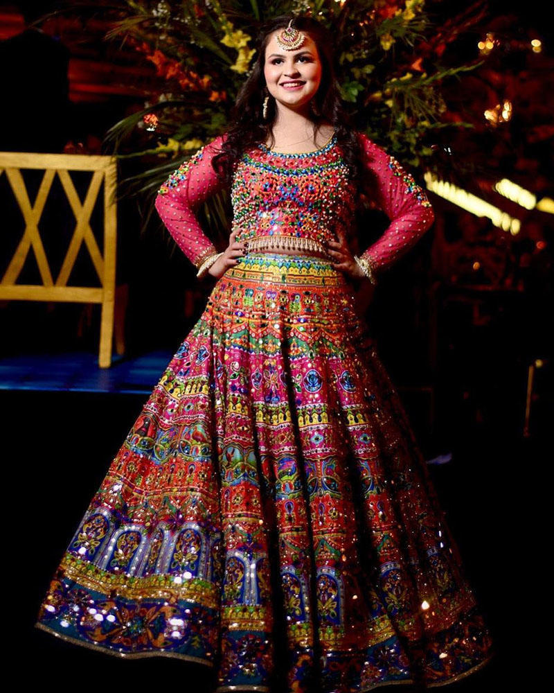 Picture of Kashish wears our truck art inspired mirrorwork lehnga choli, all in gorgeous bright hues.