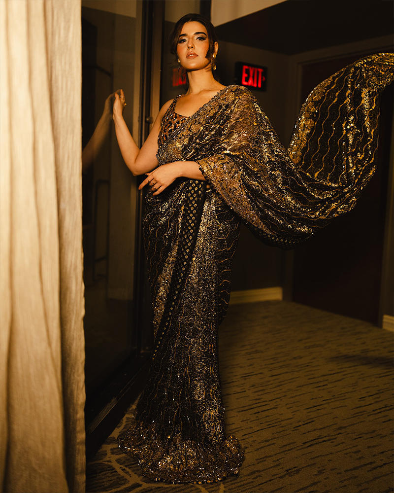 Picture of A richly bedazzled leopard print blouse to complement the classic black and gold combination of this luxe saree, made especially for Hareem